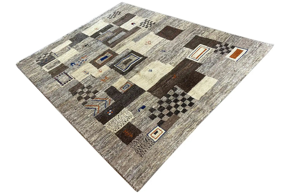 Gabbeh rug in a patchwork look: light areas, brown-black blocks, blue and orange details