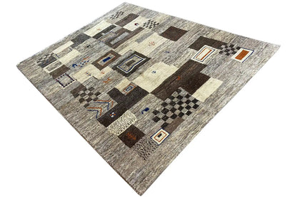 Gabbeh rug in a patchwork look: light areas, brown-black blocks, blue and orange details