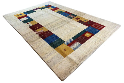 Gabbeh rug 305x200 cm, angled: cream base with blue, red, and yellow border blocks