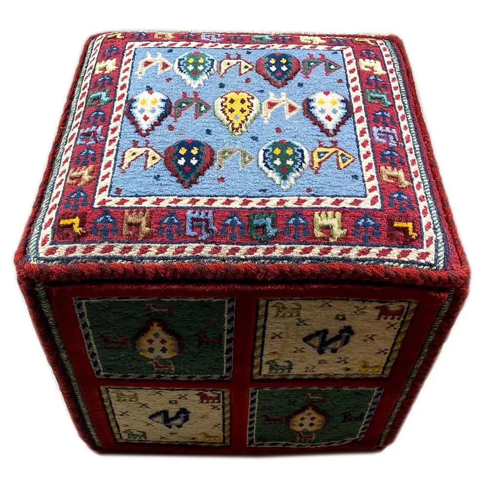 Carpet cube with a blue-and-white top edge and four side panels in red, green, and beige