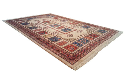 Rectangular oriental rug with border and geometric patterns in red, blue, and beige