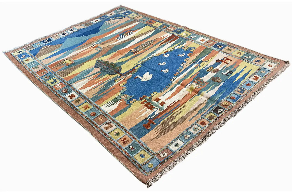 Slanted kilim rug with a landscape motif, blue center, and multicolored border