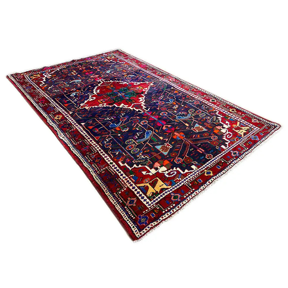 Hamadan rug with a dark background, wide border, and multicolored medallion.