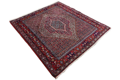 Diamond-cut carpet with a central medallion, red-and-blue pattern, and border ornamentation