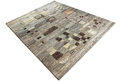 Gray Gabbeh rug with brick and diamond patterns in beige, red, and black