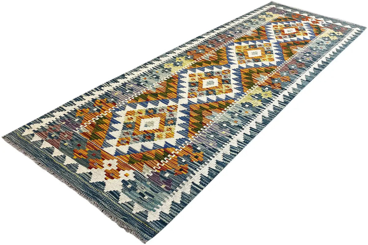 Afghan kilim runner, lying diagonally, diamond-shaped fields with colorful ornaments.