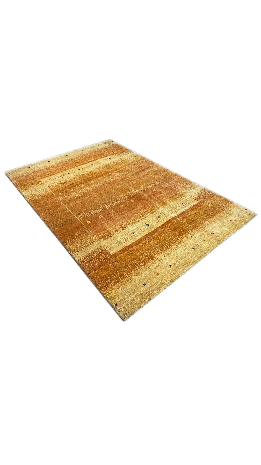 Gabbeh rug, laid at an angle, patterned in honey brown and light beige
