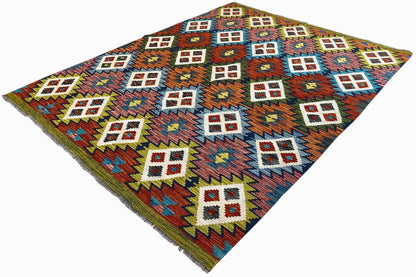 Kilim Afghan rug at an angle, geometric symbols in multiple colors