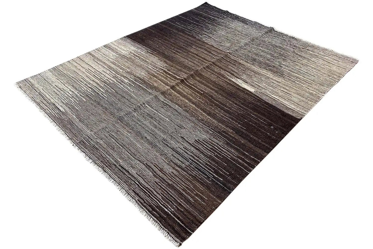 Kilim Qashqai rug with speckled stripes in brown and gray, visible fringes along the edge
