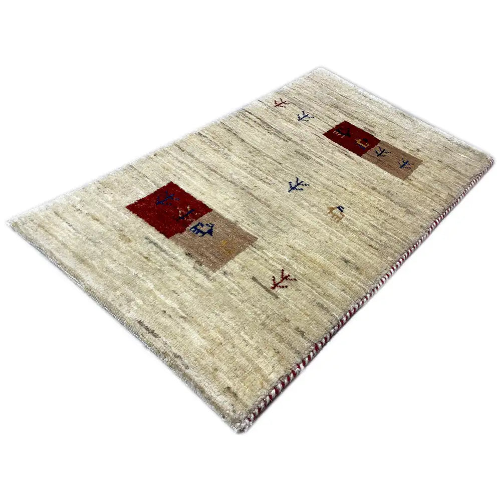 Rectangular Gabbeh rug with beige pile and red and blue motif squares