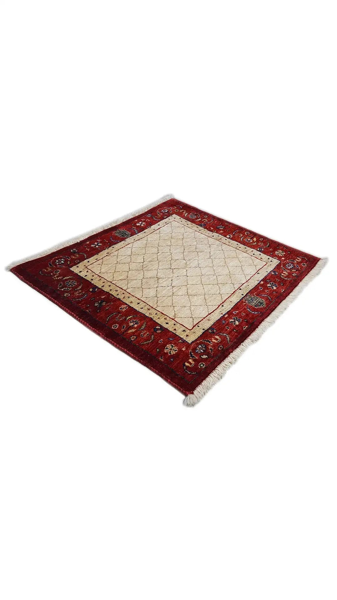 Square rug with a red border design and beige central field, fringes