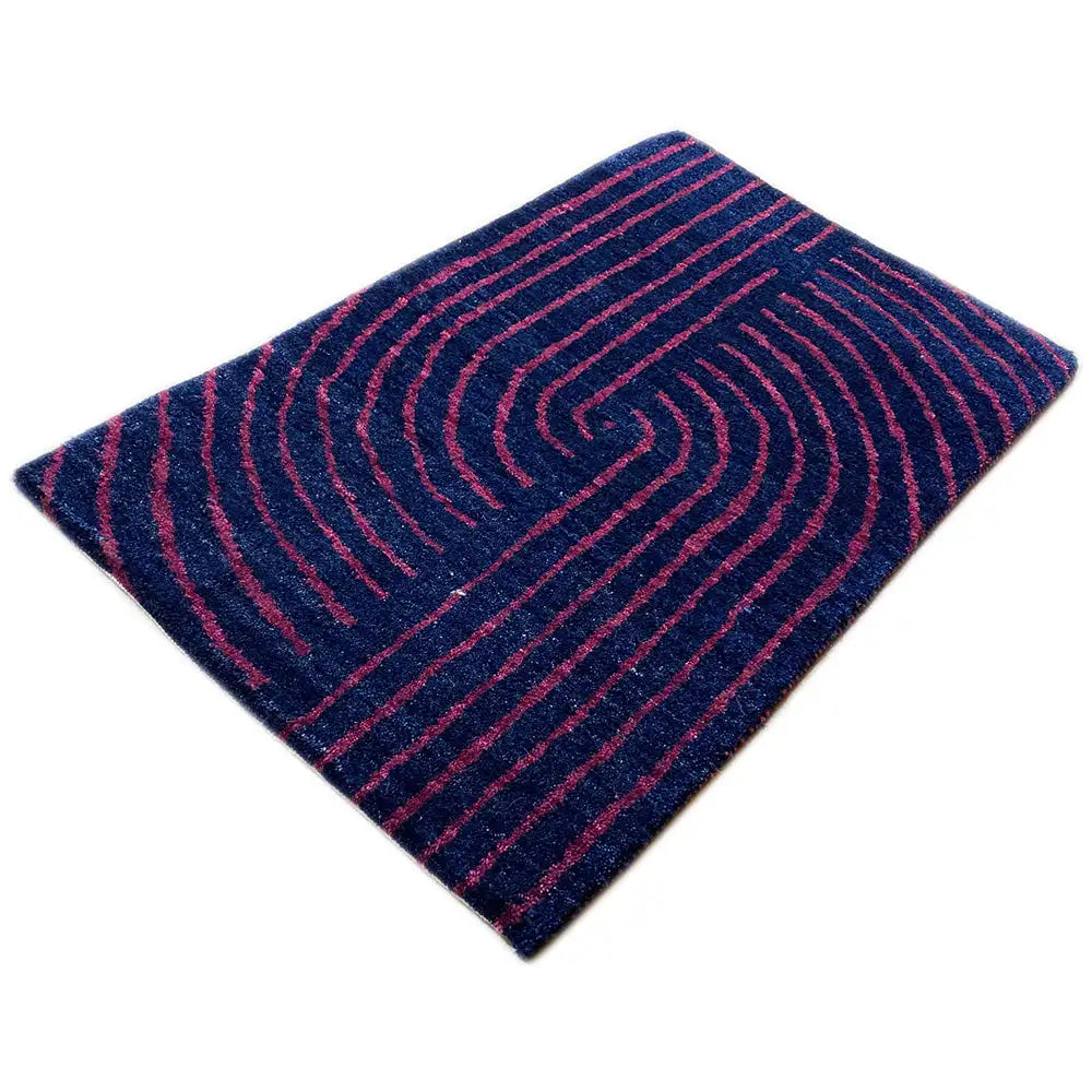Gabbeh rug, diagonal view: whirlpool-like lines in dark blue and pink