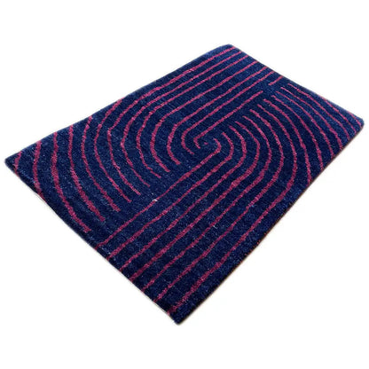 Gabbeh rug, diagonal view: whirlpool-like lines in dark blue and pink