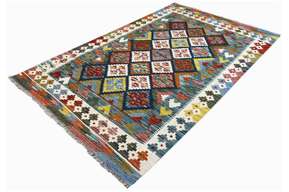 Kilim rug, diagonal view with colorful diamonds, squares, and braided border