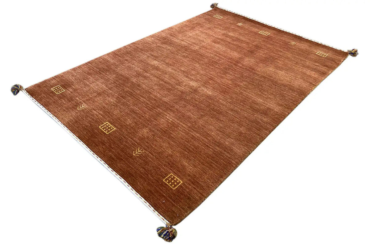 Brown woven rug with evenly spaced gold ornaments and fringes at the corners