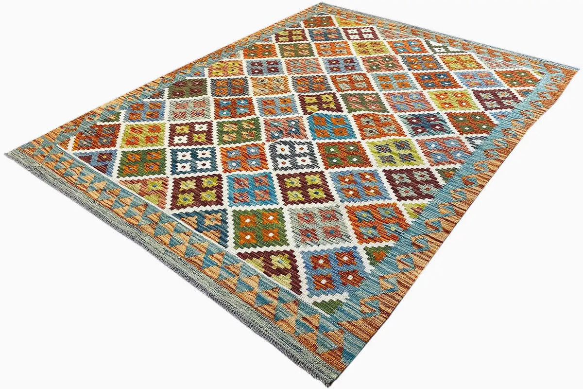 Kilim rug spread at an angle, diamond-check pattern in blue, orange, green, and yellow