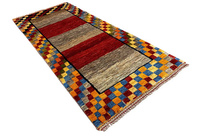 Gabbeh rug (190x83 cm), diagonal close-up: red-gray rectangles with a yellow-blue tile border.