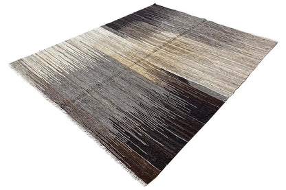 Kilim rug with patterned areas in dark brown, gray, and light beige.