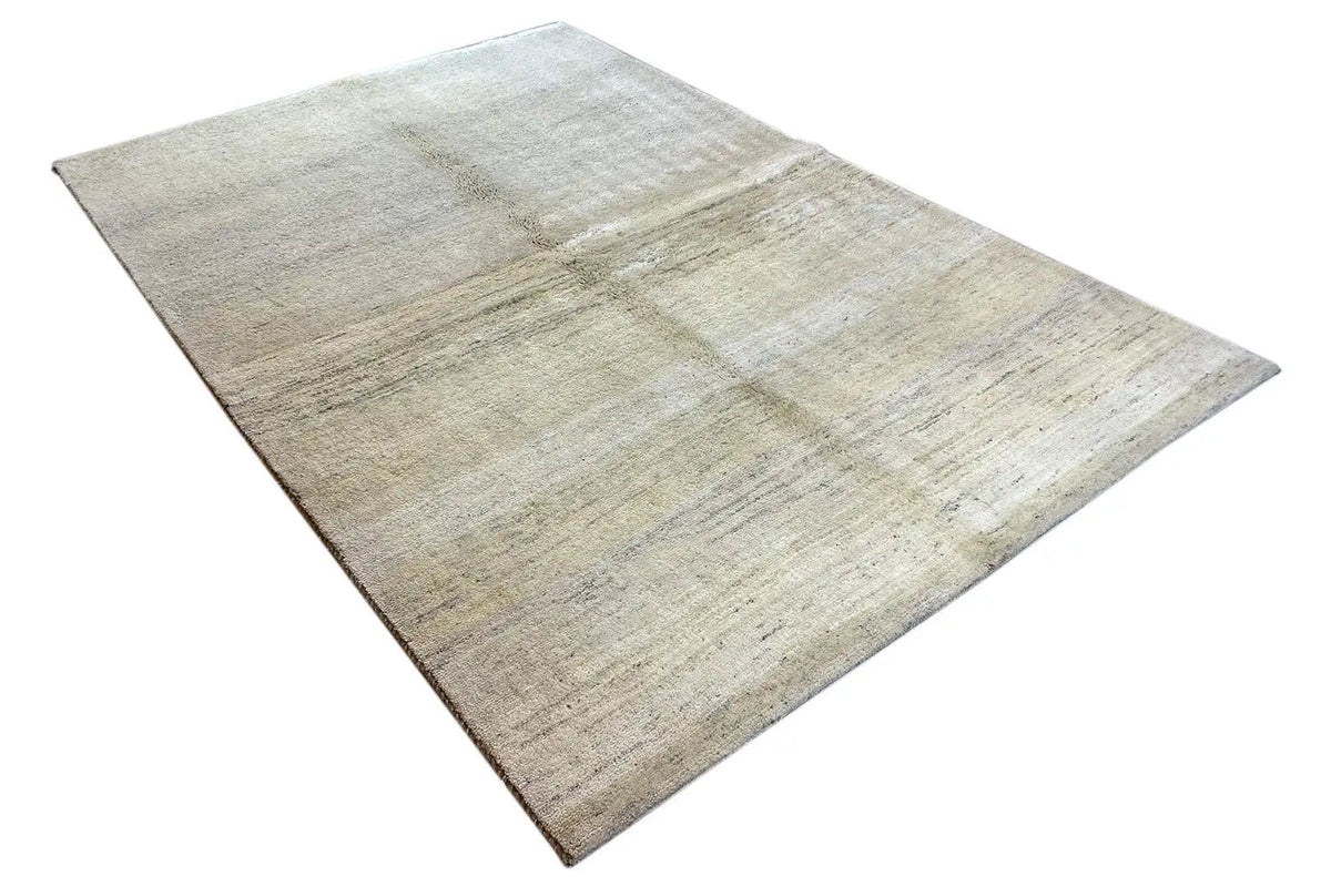 Gabbeh rug, light beige surface with a subtle linear pattern and a visible edge
