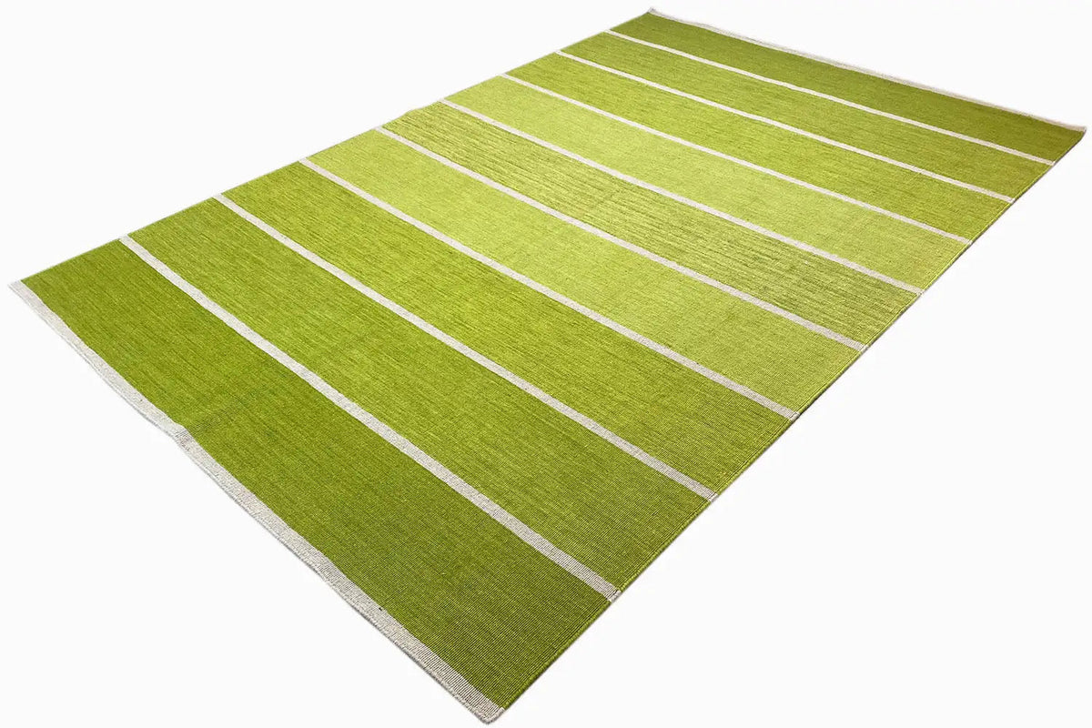 Green kilim rug with light longitudinal stripes, spread out; visible selvedge