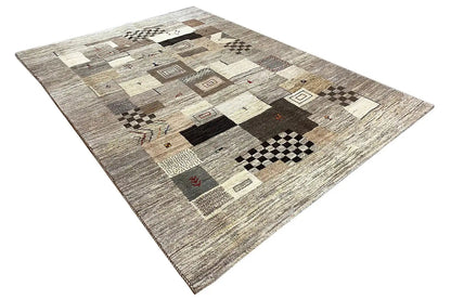 Gabbeh rug, shown at an angle: patchwork of squares and diamonds in gray/beige
