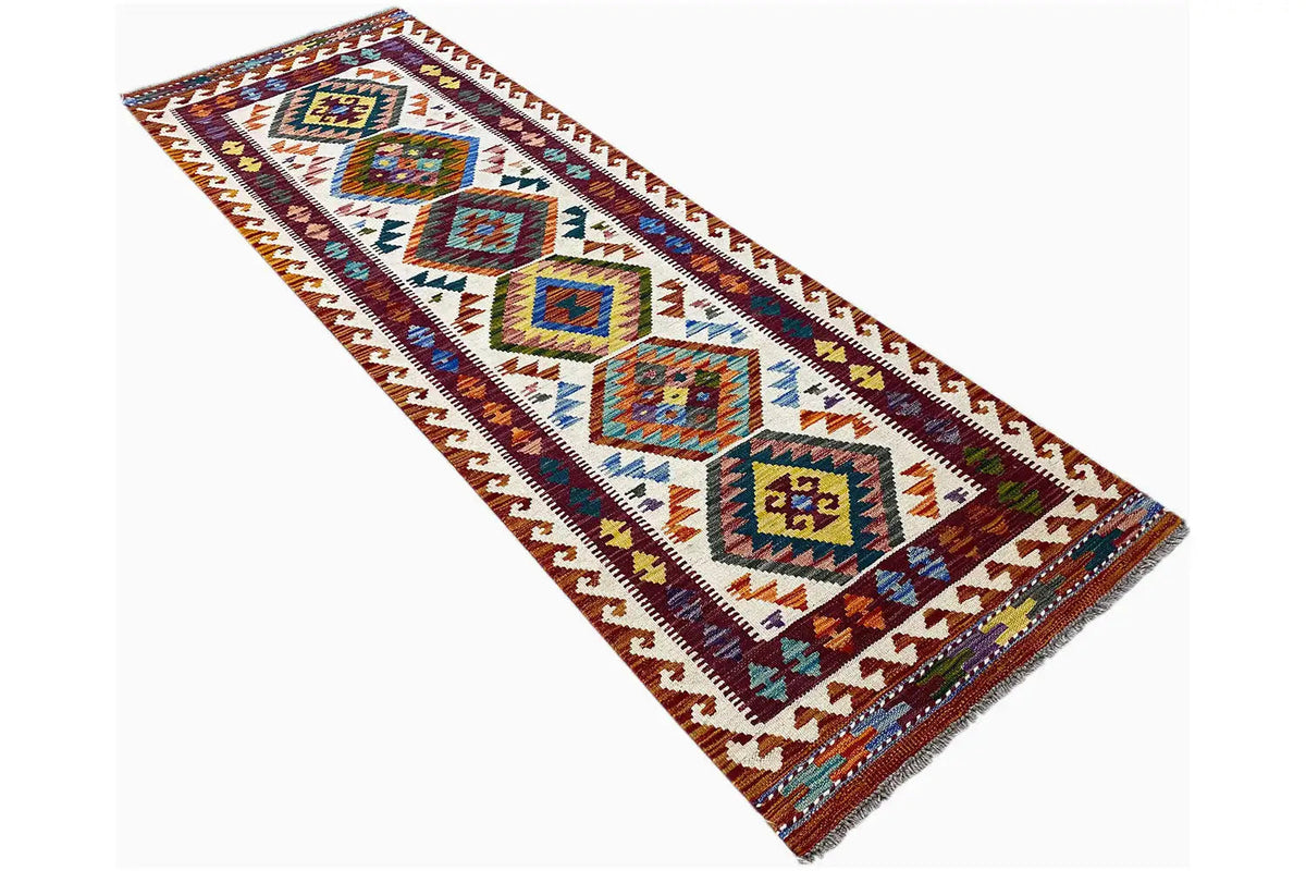 Afghan kilim runner with diagonal zones of geometric patterns and fringes
