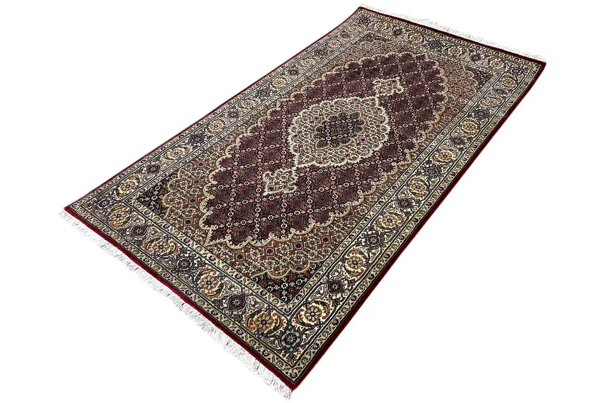 Indo-Tabriz rug: elongated design with a rotated medallion rug pattern