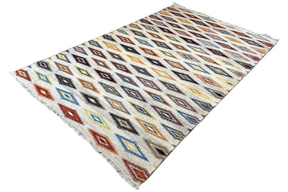 Kelim dhurrie rug at an angle, checkerboard-style diamonds in blue, red, and orange