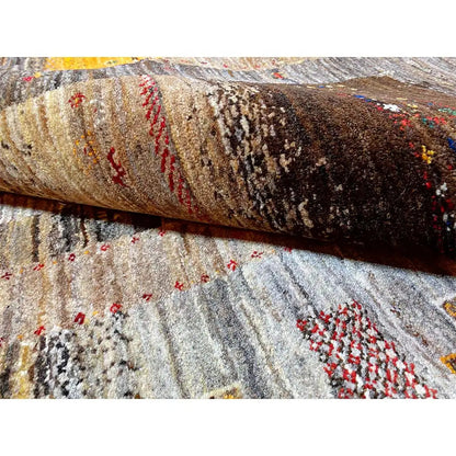 Close-up of a Gabbeh rug: pile with multicolored details in brown, red, and beige