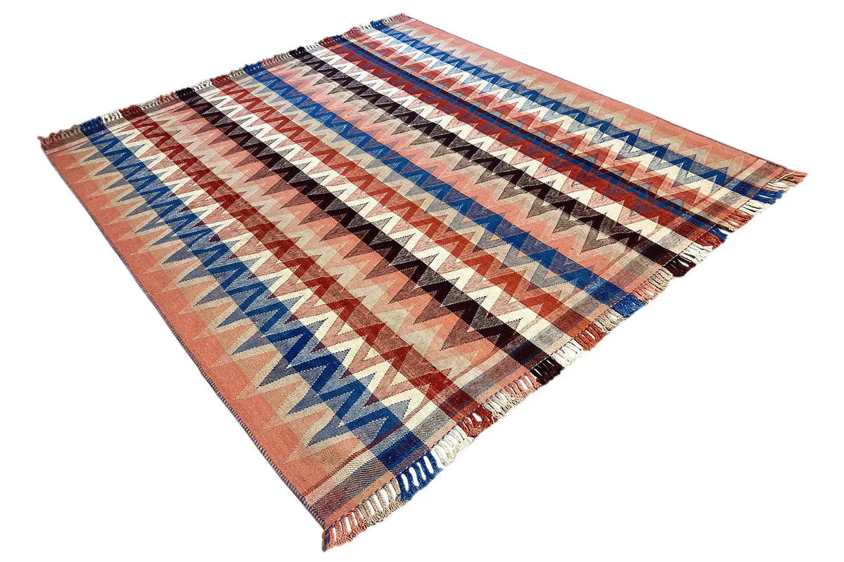 Rug with a triangular design: zigzag pattern in rust, blue, and beige, with fringes