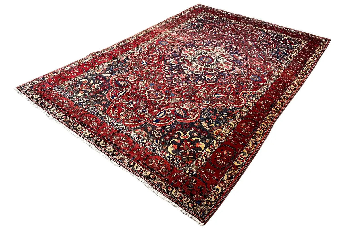 Red floral rug with a central medallion and richly embellished surface ornamentation