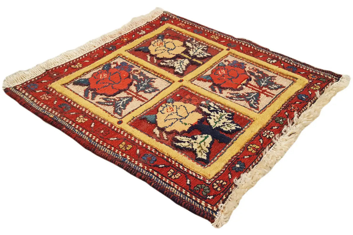Square rug with multicolored floral patterns and fringes, red background, 48x42 cm