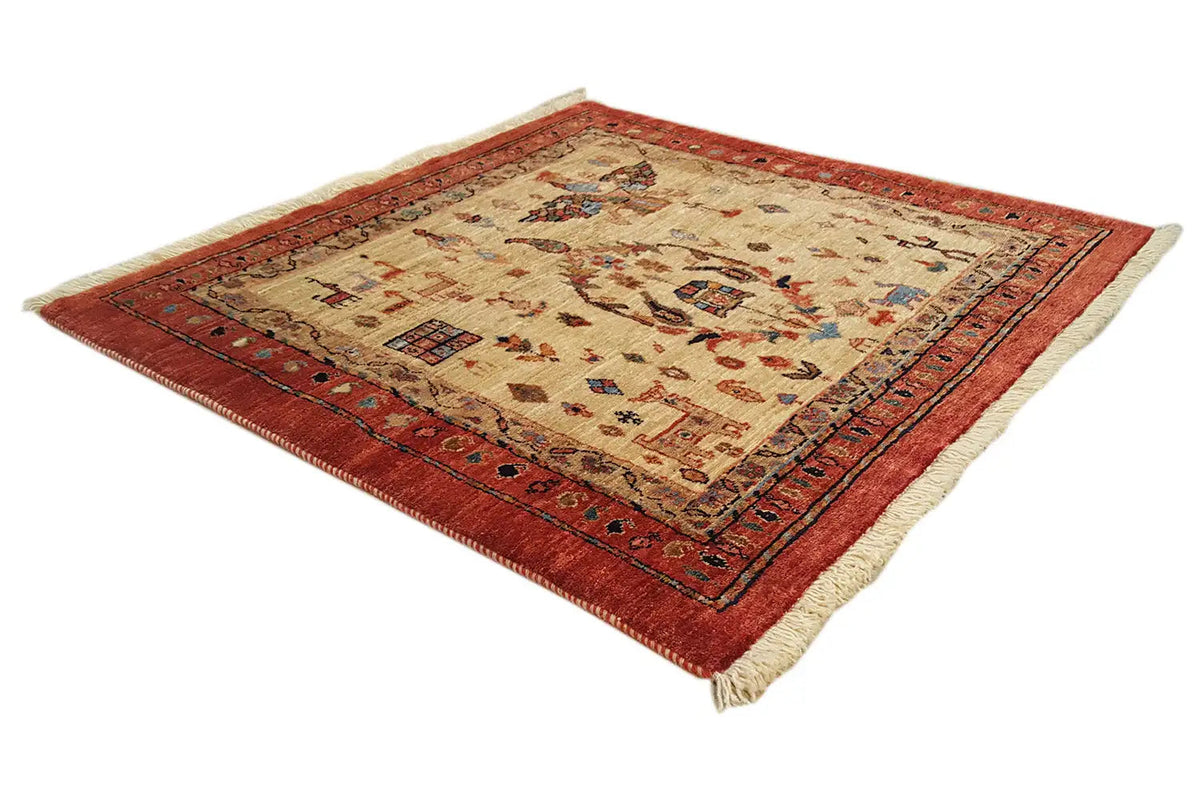 Oriental rug with a beige center, red border, and decorative edging, laid diagonally.