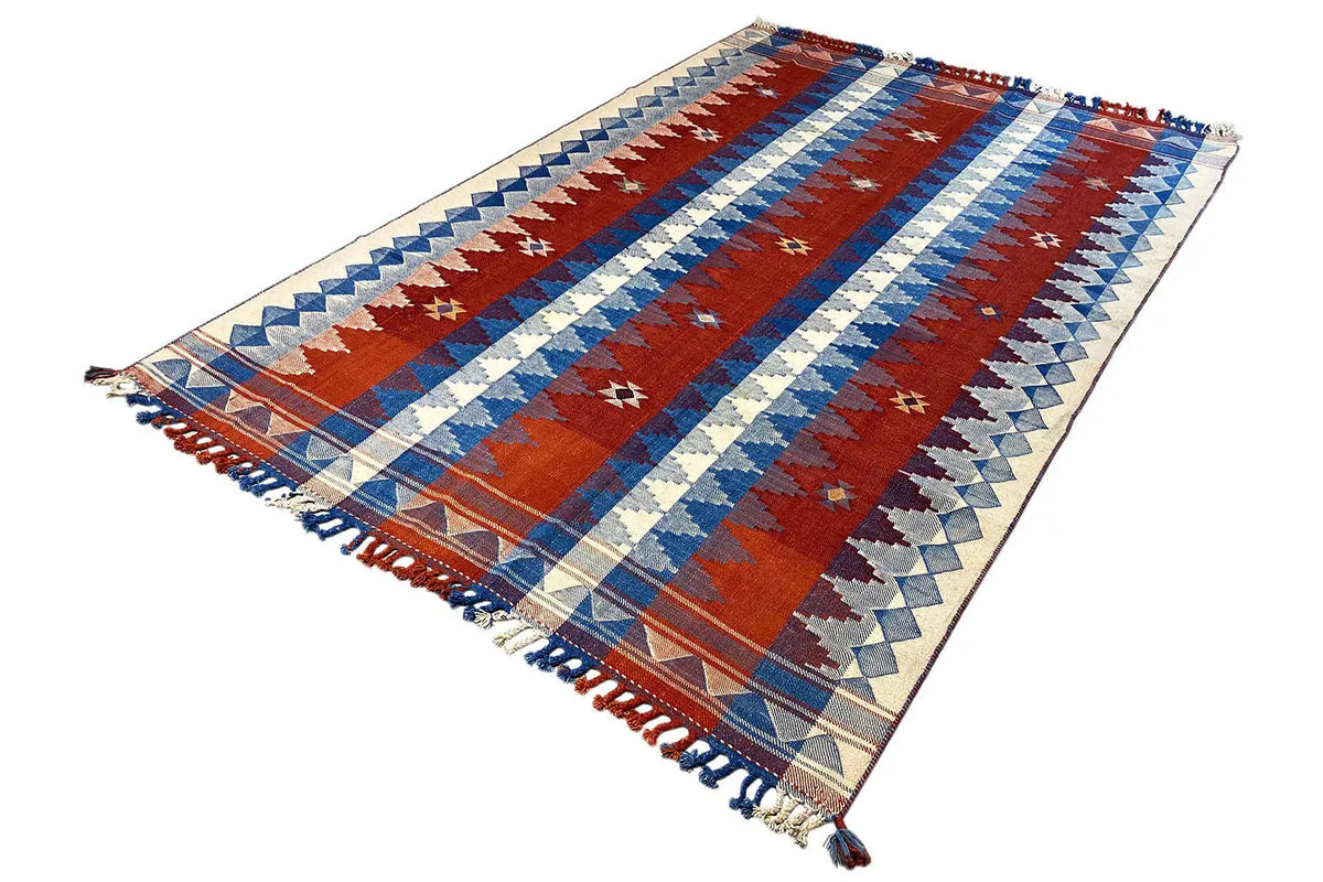 Striped rug in red, blue and cream, with fringes and a narrow border