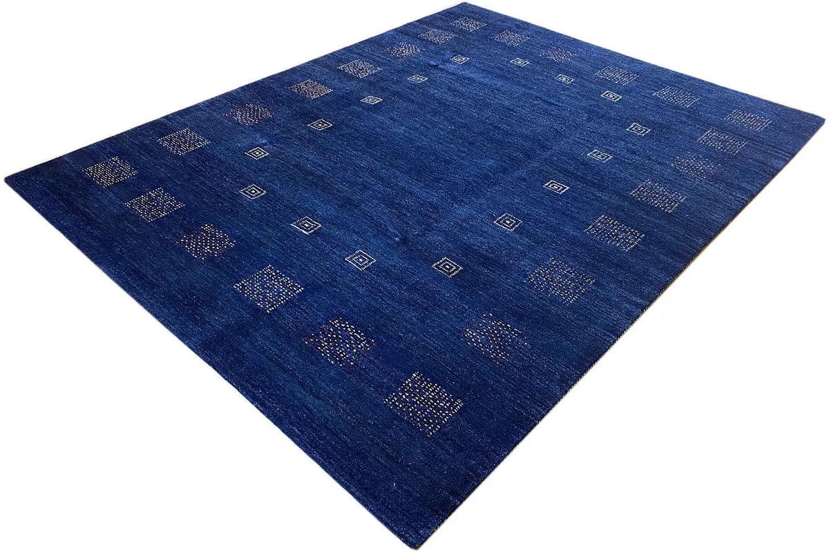 Blue rug with clear square patterns and subtle color accents