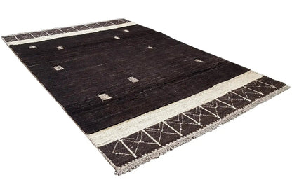 Dark brown Gabbeh rug with a light beige central border, zigzag edge border and fringes