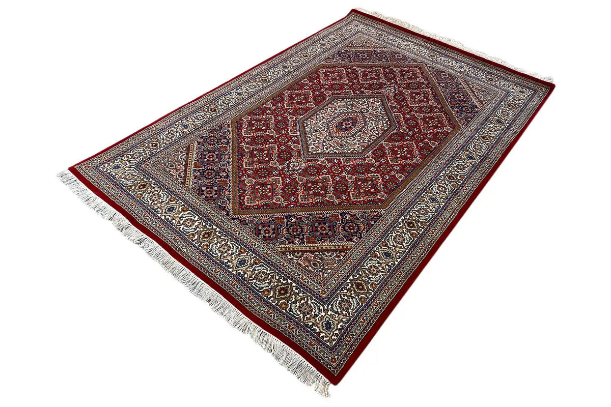 Rug 186x123 cm with red diamond medallion, blue-gray border, and white fringes