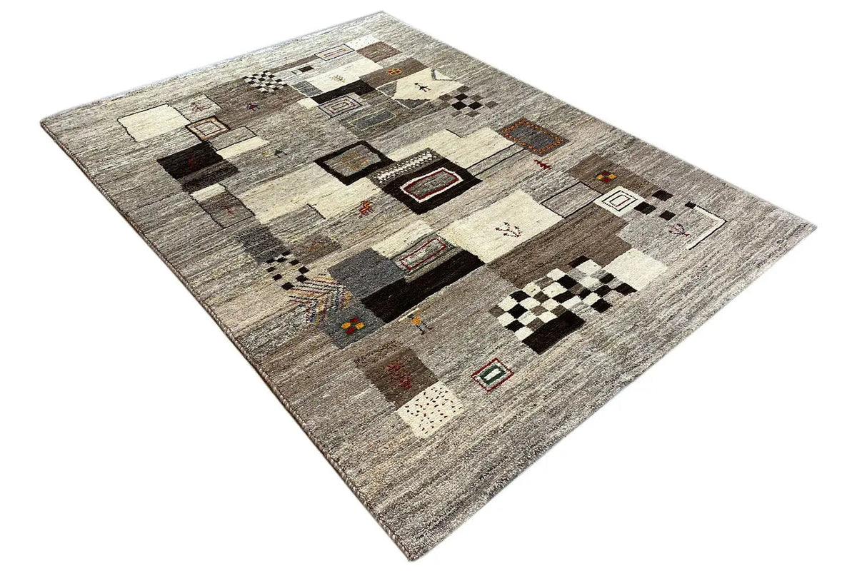 Gabbeh rug: geometric patchwork elements in gray/beige, diagonal view