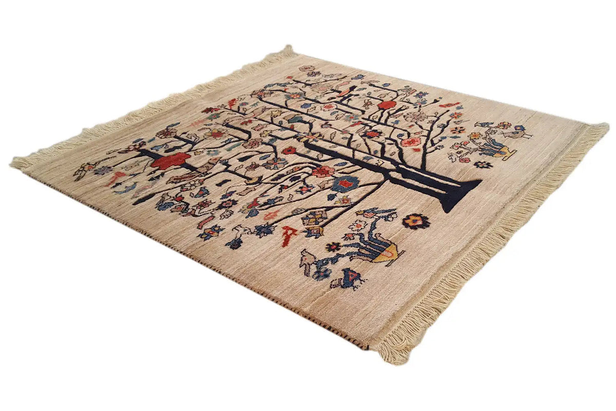 Beige rug with tree ornaments and colorful floral motifs, fringed edge.