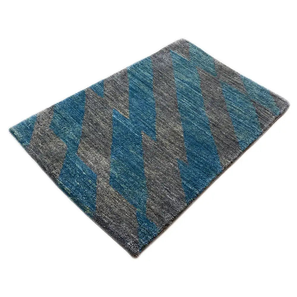 Rug with zigzag-like stripes in shades of blue and gray, rectangular, 90x55 cm