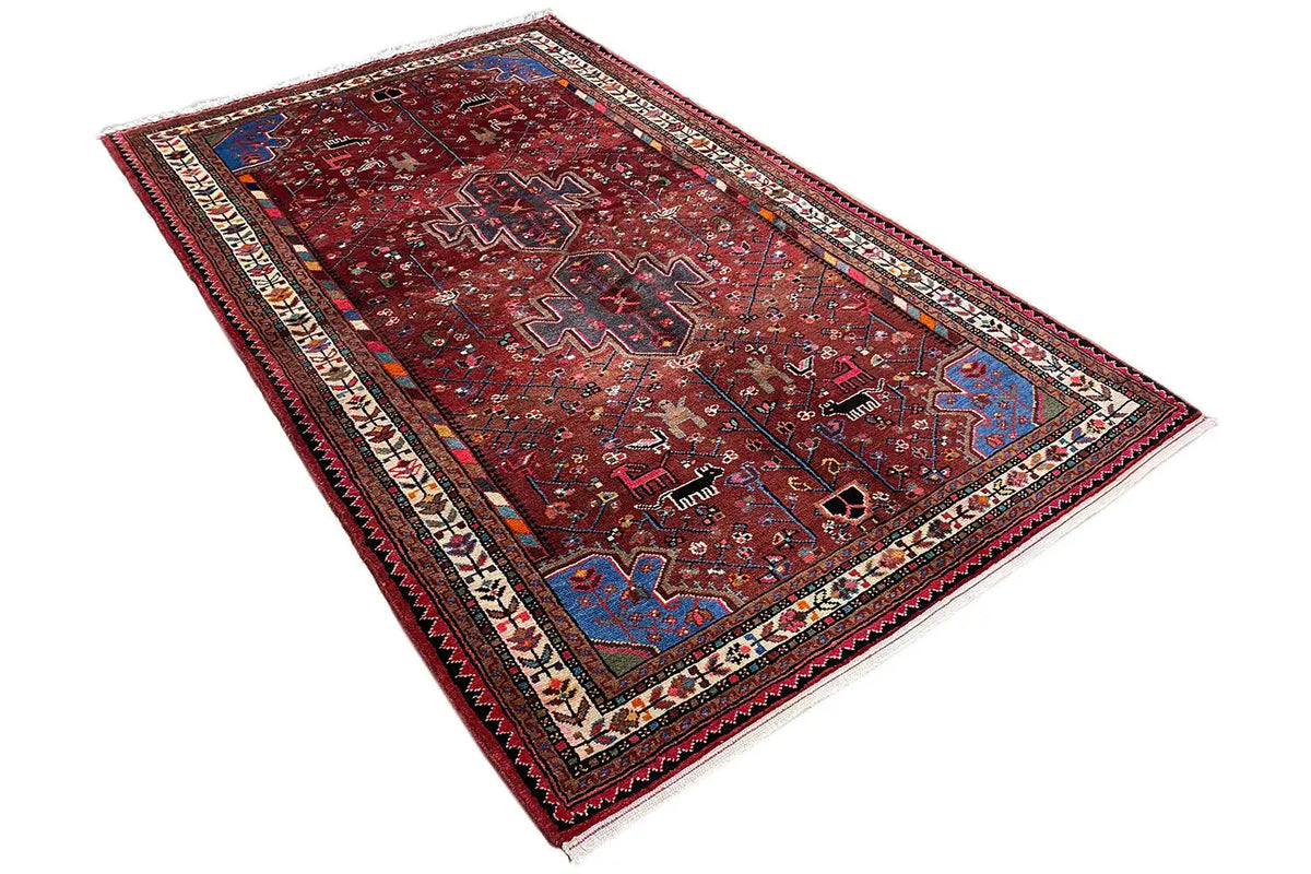 Hamadan rug with a red background, central motifs, and an ornamental border area