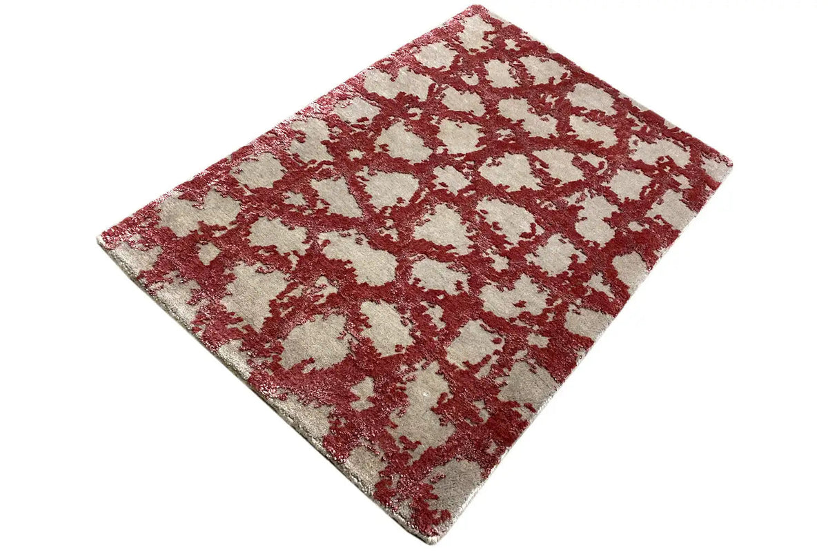 Carpet in diagonal view: red ornament on a light background
