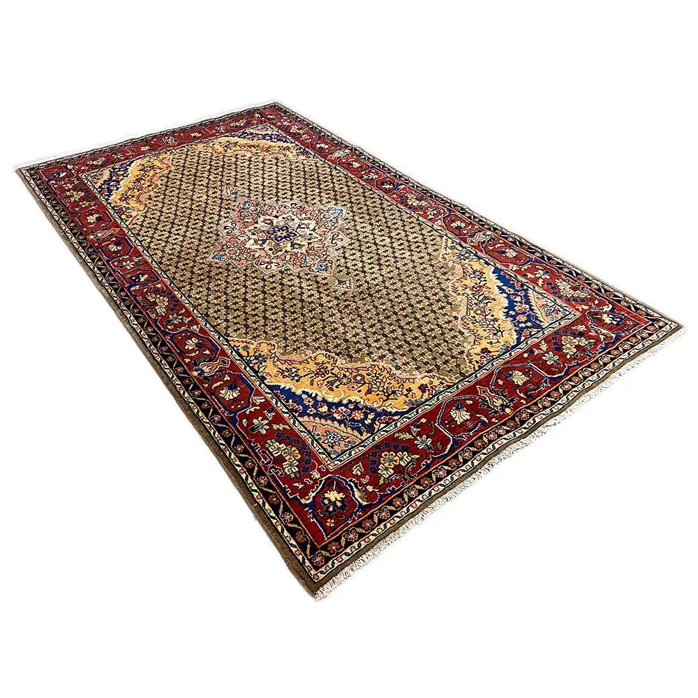 Beige Hamadan rug with a red border and blue accents, trapezoidal perspective