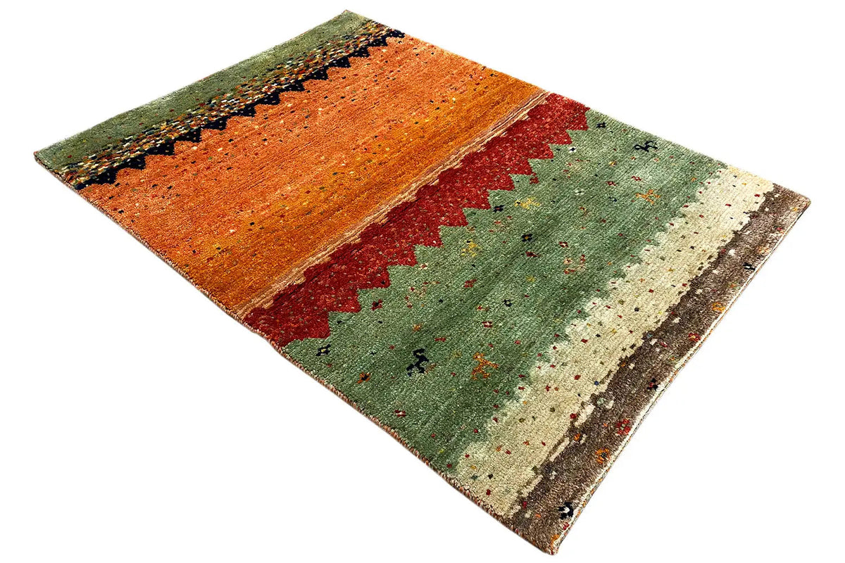 Lori Gabbeh rug in green with an orange-red central stripe and a diagonal zigzag pattern.