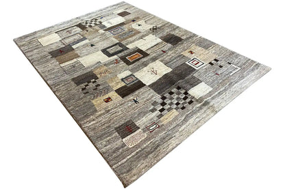 Rectangular rug with abstract patchwork areas in light beige, gray, and dark brown