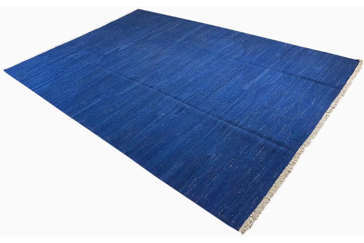 Blue kilim rug with beige edging, diagonal overall view