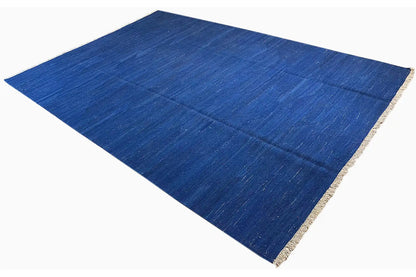 Blue kilim rug with beige edging, diagonal overall view