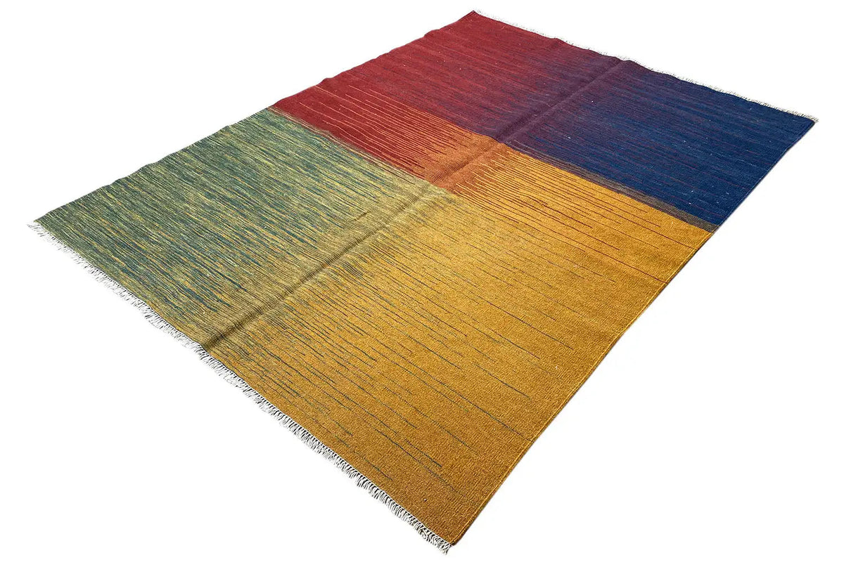 Kilim rug at an angle, red area at the top, wide stripes in blue, yellow, and green, fringes