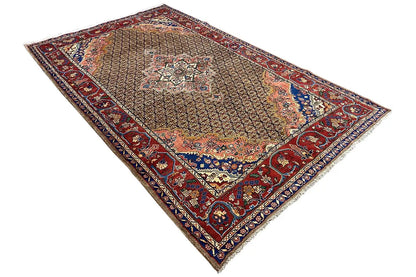 Oriental rug with a geometric border and medallion, shades of red, blue, and beige