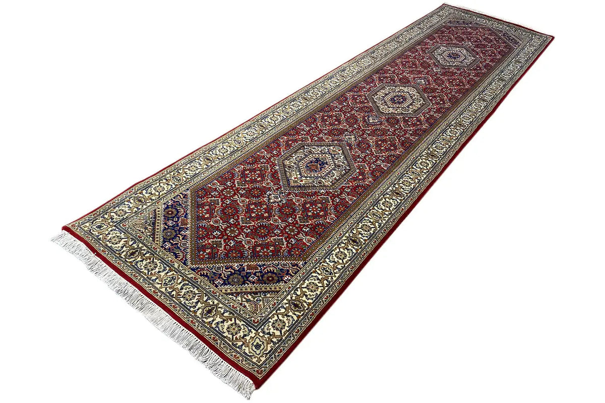 Bidjar runner diagonal: red field with multiple medallions, light border ornament